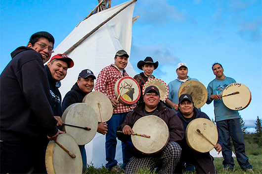 James Gang Drummers posed in front of teepee